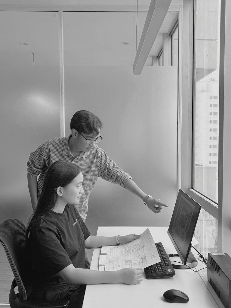 Person pointing at a large monitor