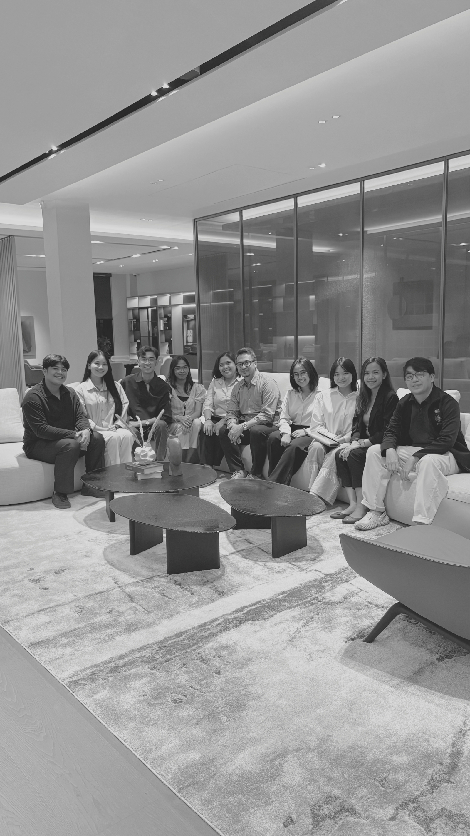 Person talking to a group next to a plant